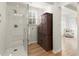 Modern tiled shower, hardwood floors, and an antique storage unit offers a unique bathroom design at 2148 Allgood Rd, Marietta, GA 30062