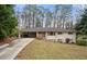 Charming ranch-style home with a long driveway and mature trees surrounding the property at 2151 Zelda Ne Dr, Atlanta, GA 30345