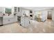 Updated kitchen with white cabinets, stainless appliances, and an island overlooking living area at 2151 Zelda Ne Dr, Atlanta, GA 30345