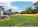 Spacious fenced backyard with lush green grass, brick patio, and a charming deck perfect for outdoor entertaining at 598 Taylor Se Dr, Smyrna, GA 30080