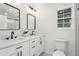 Bright bathroom features dual sinks, modern fixtures, a large mirror, and a window for natural light at 598 Taylor Se Dr, Smyrna, GA 30080
