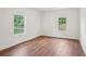 Bedroom with hardwood floors and bright natural light from the two windows at 598 Taylor Se Dr, Smyrna, GA 30080