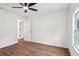Bright bedroom with hardwood floors, ceiling fan, and natural light from a window at 598 Taylor Se Dr, Smyrna, GA 30080