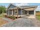 Beautifully renovated home with a welcoming front porch, carport, and modern exterior finishes and new landscaping at 598 Taylor Se Dr, Smyrna, GA 30080