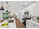 Gourmet kitchen showcases sleek white cabinets, modern appliances, and a seamless connection to the dining area at 598 Taylor Se Dr, Smyrna, GA 30080