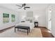 Inviting main bedroom features a comfy bed, stylish bench, bedside tables and lamps, with backyard views at 598 Taylor Se Dr, Smyrna, GA 30080