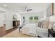 Spacious main bedroom boasts windows and natural lighting, plush bed, and backyard access to the outdoors at 598 Taylor Se Dr, Smyrna, GA 30080