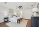Bright main bedroom with decoratively pillowed king bed, bench, and stylish lighting with a bathroom entrance at 598 Taylor Se Dr, Smyrna, GA 30080