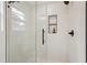 Modern shower features glass door, rainfall shower head, built-in niche, and unique textured white tile at 598 Taylor Se Dr, Smyrna, GA 30080