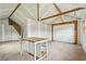Interior view of workshop, showing unfinished drywall, a work table and garage door at 598 Taylor Se Dr, Smyrna, GA 30080