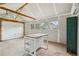 Interior view of workshop, showing unfinished drywall, a work table and a roll-up garage door at 598 Taylor Se Dr, Smyrna, GA 30080