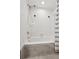 Bathtub with tiled walls, a shower head, and modern fixtures at 101 Swanton Hill Ct, Decatur, GA 30030