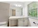 Bright bathroom featuring tub, sink and vanity combo, and large window at 101 Swanton Hill Ct, Decatur, GA 30030