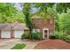 Charming brick home with lush landscaping and a welcoming front entrance surrounded by mature trees at 101 Swanton Hill Ct, Decatur, GA 30030