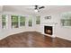 Spacious living room featuring a fireplace, hardwood flooring, ceiling fan, and bay window at 101 Swanton Hill Ct, Decatur, GA 30030
