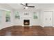 Spacious living room featuring a fireplace, hardwood flooring, ceiling fan, and built-in cabinets at 101 Swanton Hill Ct, Decatur, GA 30030