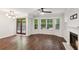 Bright living room with hardwood floors, fireplace, bay window, and French doors at 101 Swanton Hill Ct, Decatur, GA 30030