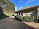A well kept backyard with a charcoal grill and green shrubs at 1360 Raven Rock Nw Trl, Kennesaw, GA 30152