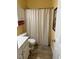 Bathroom featuring a shower with shower curtain, toilet, sink with vanity and storage cabinet at 1360 Raven Rock Nw Trl, Kennesaw, GA 30152