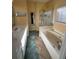 Well-lit bathroom with double sink vanity, large tub, walk-in shower, and tile flooring at 1360 Raven Rock Nw Trl, Kennesaw, GA 30152