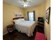 Cozy bedroom featuring a comfortable bed, ceiling fan, and natural light from the window at 1360 Raven Rock Nw Trl, Kennesaw, GA 30152