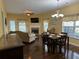 The living room is bathed in natural light and contains hardwood floors and a fireplace at 1360 Raven Rock Nw Trl, Kennesaw, GA 30152