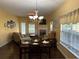 The living room is bathed in natural light and contains hardwood floors and a fireplace at 1360 Raven Rock Nw Trl, Kennesaw, GA 30152