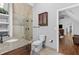 This bathroom has a wood vanity, granite countertops, and a tiled shower with glass doors, plus extra storage at 150 South St, Buford, GA 30518
