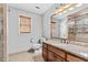 Full bathroom with granite countertops, wooden vanity, large mirror, and tiled shower at 150 South St, Buford, GA 30518