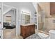 This bathroom has a wood vanity with granite countertops and a tiled shower with glass doors at 150 South St, Buford, GA 30518