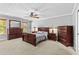 Bedroom with full wooden bedroom set, ceiling fan, and carpeted floors at 150 South St, Buford, GA 30518