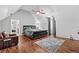 This bedroom has hardwood flooring, neutral paint, and a high ceiling adding architectural interest at 150 South St, Buford, GA 30518