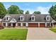Charming home featuring a well-maintained lawn, a 3 car garage and classic dormer windows at 150 South St, Buford, GA 30518