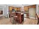 Traditional kitchen featuring wood cabinets, backsplash, bar seating, and stainless steel appliances at 150 South St, Buford, GA 30518