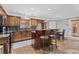 Well-lit kitchen featuring a breakfast bar with seating and attractive wood cabinetry at 150 South St, Buford, GA 30518