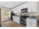 Beautiful kitchen equipped with modern appliances, gray countertops, and bright white cabinets at 150 South St, Buford, GA 30518