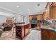 Gourmet kitchen featuring a breakfast bar, stainless steel appliances, and wood cabinets at 150 South St, Buford, GA 30518