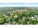 Real estate aerial shot displaying the neighborhood, trees, and local business at 150 South St, Buford, GA 30518