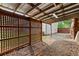 Shaded patio area with lattice design and gravel base, offering a private outdoor space at 150 South St, Buford, GA 30518