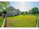 Expansive backyard featuring lush green grass, a fenced perimeter, and a screened porch at 815 Spring View Ct, Covington, GA 30014