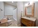 Bathroom with granite countertop, wood vanity, decorative mirror and tile flooring at 815 Spring View Ct, Covington, GA 30014