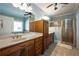 Bathroom with dual sinks, custom wood cabinets, walk-in shower and soaking tub at 815 Spring View Ct, Covington, GA 30014