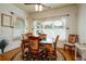 Bright dining room with hardwood floors and windows with decorative curtains at 815 Spring View Ct, Covington, GA 30014