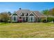 Beautiful brick home featuring a manicured lawn, complemented by decorative landscaping and large windows at 815 Spring View Ct, Covington, GA 30014