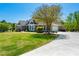 A beautiful home featuring a well-manicured lawn and driveway, with mature trees and landscaping at 815 Spring View Ct, Covington, GA 30014