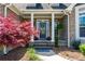 Charming front porch entrance with decorative columns, seasonal wreath, and colorful landscaping at 815 Spring View Ct, Covington, GA 30014