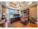 Cozy home office with a large desk, bay window, and built-in bookshelves at 815 Spring View Ct, Covington, GA 30014
