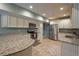 Spacious kitchen with stainless appliances, granite countertops, and cream-colored cabinets at 815 Spring View Ct, Covington, GA 30014