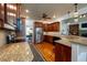 Spacious kitchen featuring custom wood cabinetry, granite countertops, and stainless steel appliances at 815 Spring View Ct, Covington, GA 30014