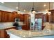 Gourmet kitchen with granite countertops, custom cabinetry, and stainless steel appliances at 815 Spring View Ct, Covington, GA 30014